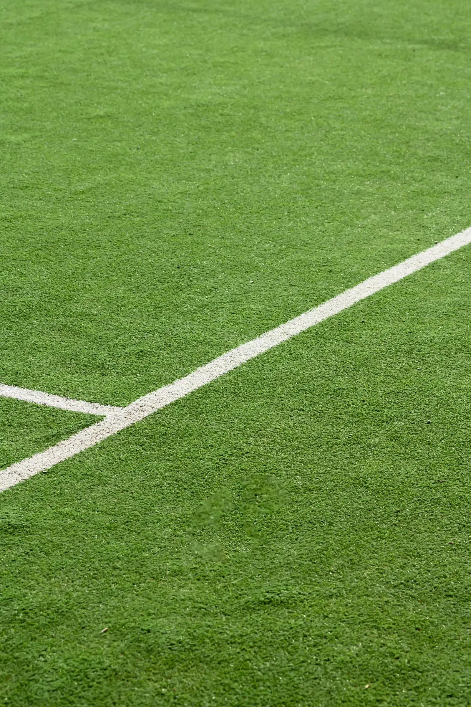 Close-up of artificial turf with white line marking